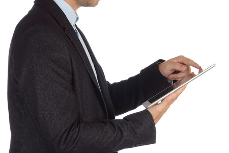 Businessman plans tasks on modern tablet isolated on white background closeup. Business idea of successful enterprising young business person.の写真素材