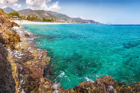 Lagoon sea beach landscape. Paradise seascape, Turkey, vacation concept. Alanya beach with rock in clean water and mountains on the horizont.の写真素材