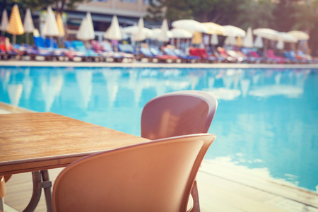 table with swimming pool view on resort hotelの写真素材