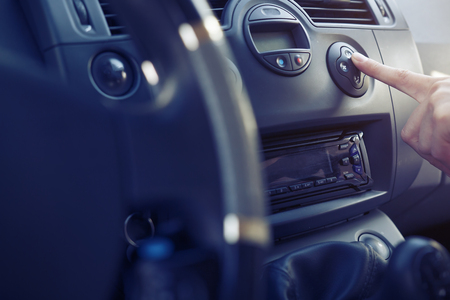 The passenger in the car presses the button climate control