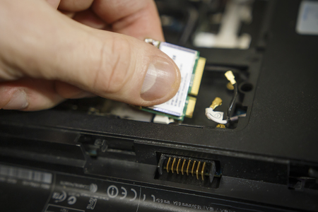 Laptop repair. Replacing parts in an old computer. Repair the electronics.の写真素材