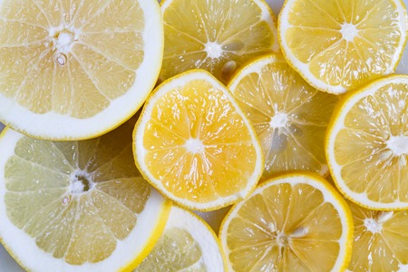 Slices of lemon and orange close-up. Vitamin C in citrus fruits. Fruit yellow backgroundの写真素材