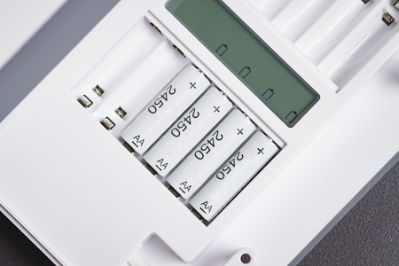 Charging for rechargeable batteries close-up. Device for charging batteries. Charge accumulators...