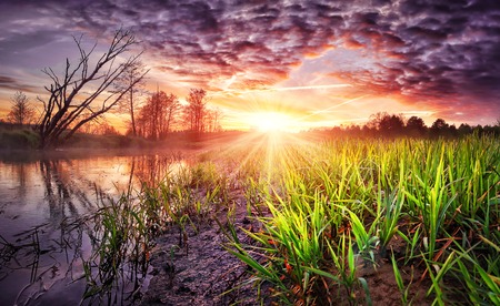 Spring landscape of colorful sunrise with beautiful sky over river. Wild spring nature in the...