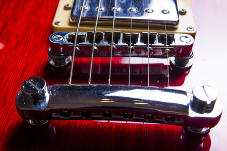 Red electric guitar close-up. Guitar in the style of Les Paul macro.の写真素材