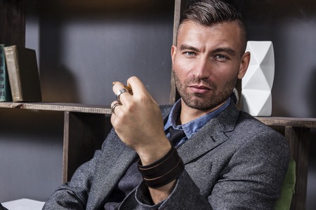 Emotional expressive portrait of a beautiful elegant man in a business suit. Young businessman with...