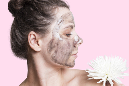 Attractive young woman with cream mask on face. Face skin care concept. Healthy smooth skin on the girl's face. Skincareの写真素材