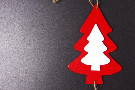 Christmas fir tree wooden toy on black background. Place for text. Xmas holidays conceptの写真素材