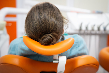 Patient in dental chair at reception at dentist. Treat your teeth with dentistの写真素材