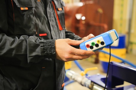 Industrial worker with measuring device on plumbing and boiler courseの写真素材