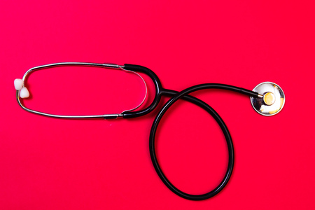 Health insurance concept. Healthcare and safety. Modern medical. Stethoscope on red backgroundの写真素材
