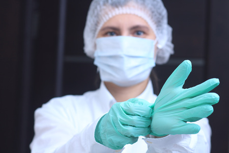 Medical worker wearing gloves before surgeryの写真素材