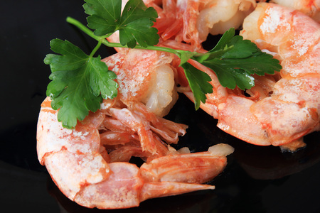 Shrimp Parsley Dish on black plate in cafe. Delicious seafoodの写真素材