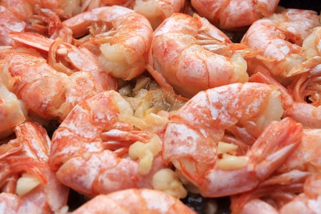 Fried shrimps in garlic sauce close-up. grilled prawn shrimps macroの写真素材
