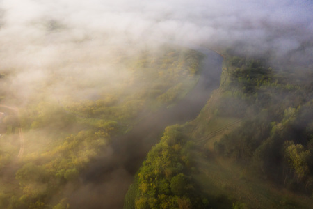 Beautiful foggy morning landscape of river view from above. Aerial view of clouds over wild river natureの写真素材