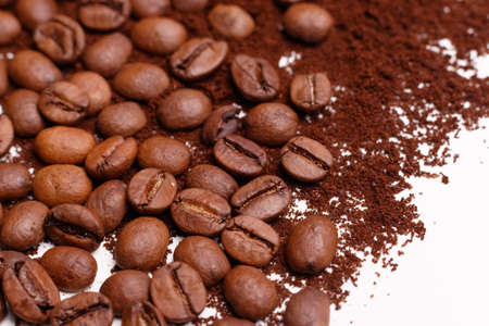 Macro shooting. Coffee beans and ground coffee on white backgroundの写真素材