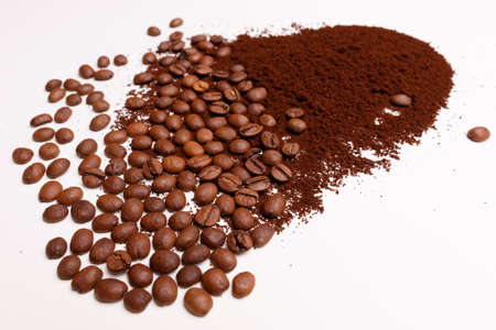 Macro shooting. Coffee beans and ground coffee on white backgroundの写真素材