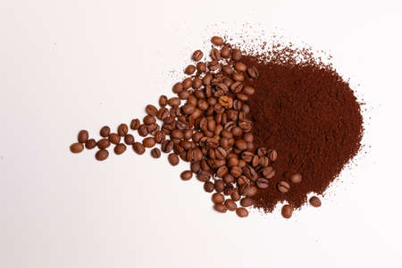 Macro shooting. Coffee beans and ground coffee on white backgroundの写真素材