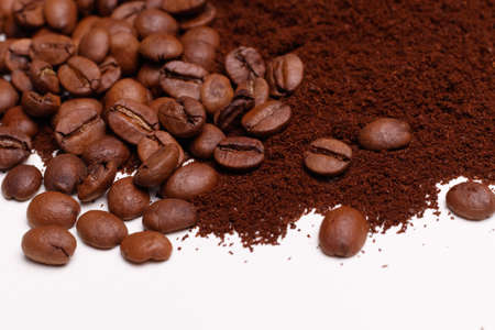 Macro shooting. Coffee beans and ground coffee on white backgroundの写真素材