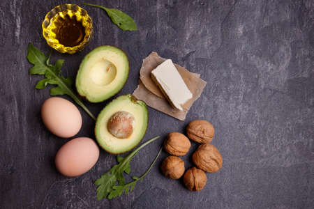Cut avocados, eggs, herbs, butter, walnuts and herbs. View from aboveの写真素材