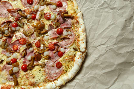 pizza with mushrooms, brisket and sausage on paperの写真素材