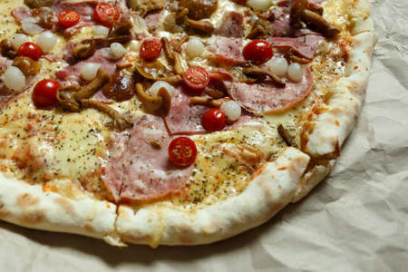 pizza with mushrooms, brisket and sausage on paperの写真素材
