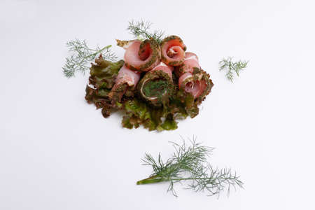 meat balyk with fresh green salad and dill on a white backgroundの写真素材