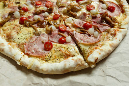 pizza with mushrooms, brisket and sausage on paperの写真素材