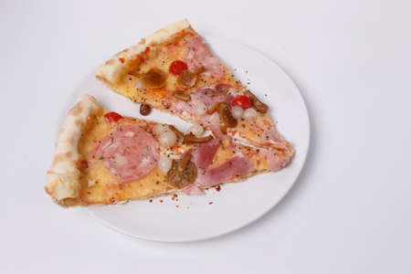sliced pizza with mushrooms, brisket and sausage in a plate on a white background