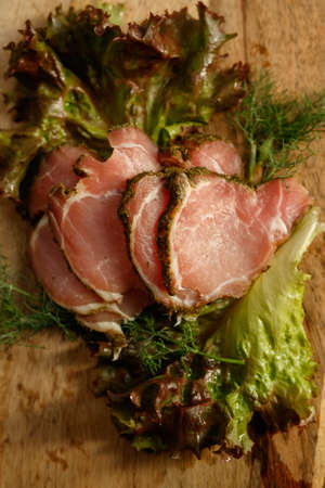 meat dish with greens on a wooden boardの写真素材