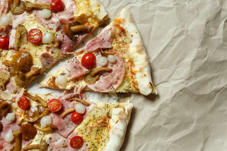 pizza with mushrooms, brisket and sausage on paperの写真素材