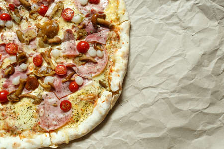 pizza with mushrooms, brisket and sausage on paperの写真素材