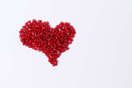 Pomegranate isolated. Pomegranate seeds on white background. Heart shape.の写真素材