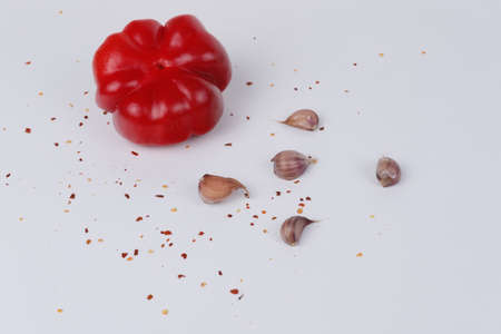 Red pepper, garlic and spices on a white backgroundの写真素材