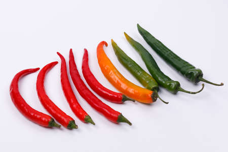 Red, yellow and green chili pepper isolated on a white background.