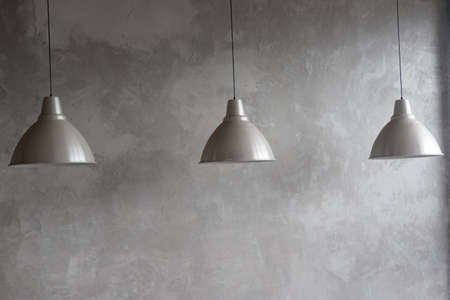 Three electric lamps of gray color on a gray background.の写真素材