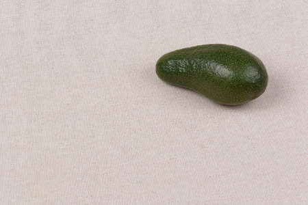 Whole avocado on a fabric background. Close-upの写真素材