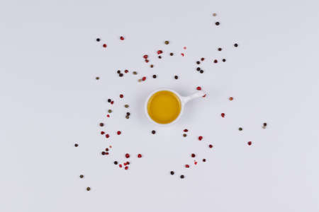Olive oil in a container on a white background, seasoning. Isolate