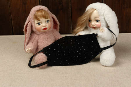 A protective mask from the virus in the hands of dolls. Coronavirus.の写真素材