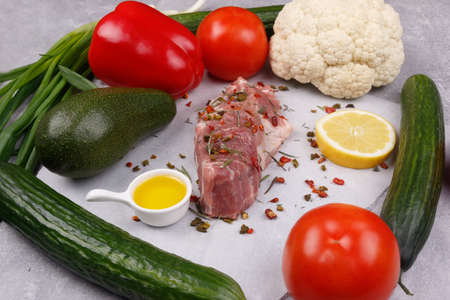 Fresh meat and vegetables for cooking your favorite dishes on a light background. View from above.の写真素材