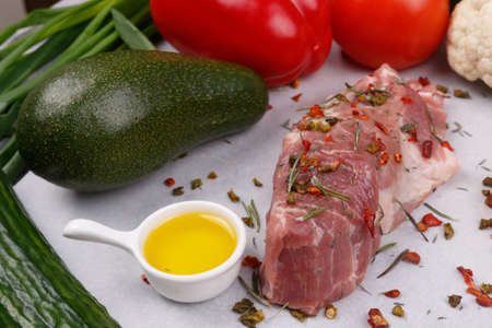 Fresh meat and vegetables for cooking your favorite dishes on a light background. View from above.の写真素材