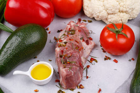 Fresh meat and vegetables for cooking your favorite dishes on a light background. View from above.の写真素材