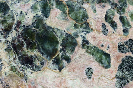 The texture of polished stone. White surface with various shades, mainly white and greenの写真素材