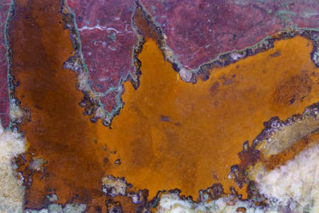Texture of polished stone in orange and purple colors.の写真素材