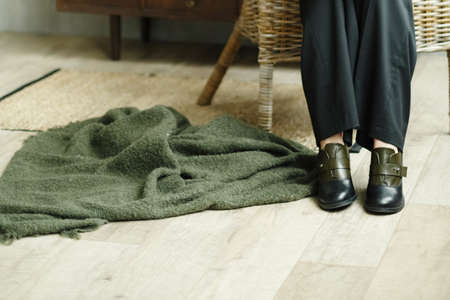 Black-green low shoes on the girlâs legs. Close up of legs, shoes and green plaidの写真素材