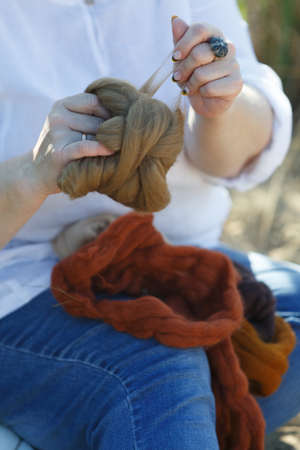 Woman hands sorting a ball of thread. Hands and threads close upの写真素材