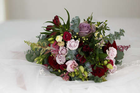 Wedding bouquet close-up on a white fabric backgroundの写真素材