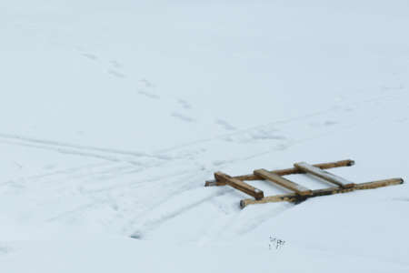 A wooden staircase lies in the snowの写真素材