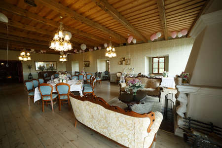 Festive interior of the room, chairs, tables set by the kitchen utensils, balloonsの写真素材