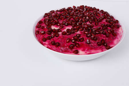 Herring salad under a fur coat in a white tarek on a white backgroundの写真素材